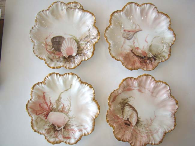 A fine and rare set of four vintage hand-painted Limoges bone china shell and flora plates circa 189
